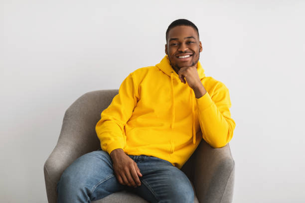 istock Black Man Posing Sitting In Armchair Posing Over Gray Background 1331311041