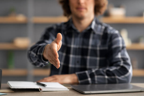 istock Businessman Stretching Hand For Handshake Greeting Sitting At Workplace, Cropped 1331311601