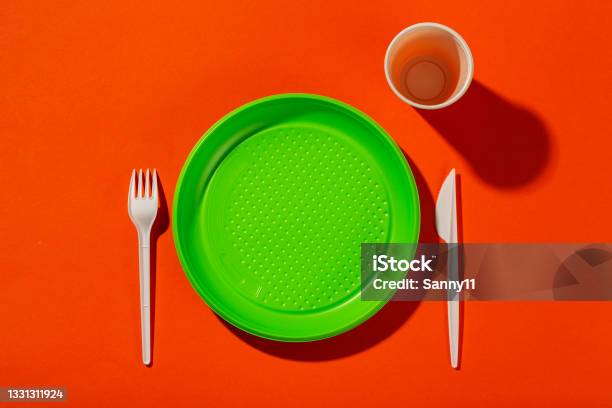 Plastic Set Of Disposable Tableware Consisting Of A Plate Knife Cup And Fork On An Orange Background Environmental Concept Ban Single Use Plastic Stock Photo - Download Image Now