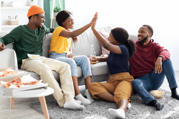 istock Two young black couples enjoying time together at home 1331312179