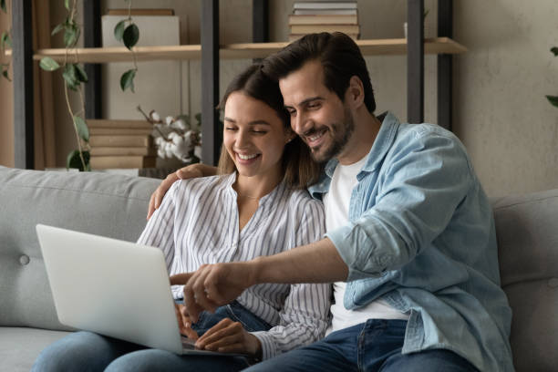 istock Couple sit on sofa enjoy easy purchasing online using laptop 1331313422