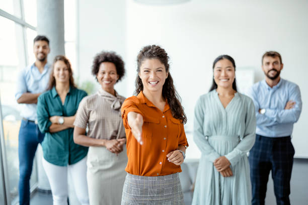 Businesswoman Offering Handshake Head shot portrait smiling businesswoman offering handshake, standing with extended hand in modern office, friendly hr manager or team leader greeting or welcoming new worker recruitment team stock pictures, royalty-free photos & images