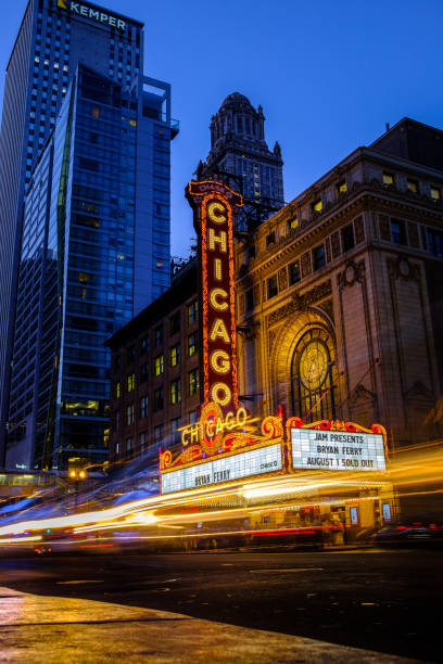 Chicago Illinois, USA. 8/1/2019. Cars drive past the iconic Chicago Theatre at dusk.
