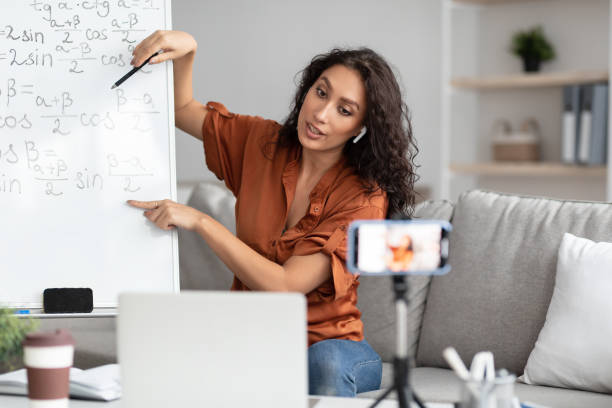 istock Mathematics teacher showing board, giving virtual lecture to students 1331321268