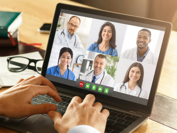 istock Closeup Of Doctor Using Laptop Video Calling Colleagues At Workplace 1331321288