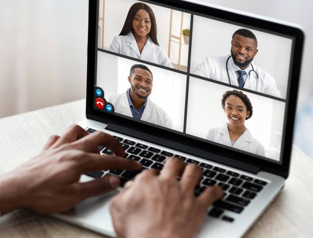 istock Black Man Using Laptop Video Calling Team Of Doctors Indoors 1331321646