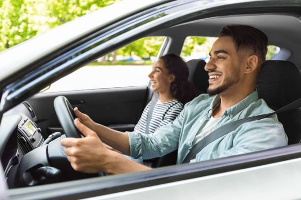 istock Cheerful middle-eastern man and woman sitting in nice car 1331322493