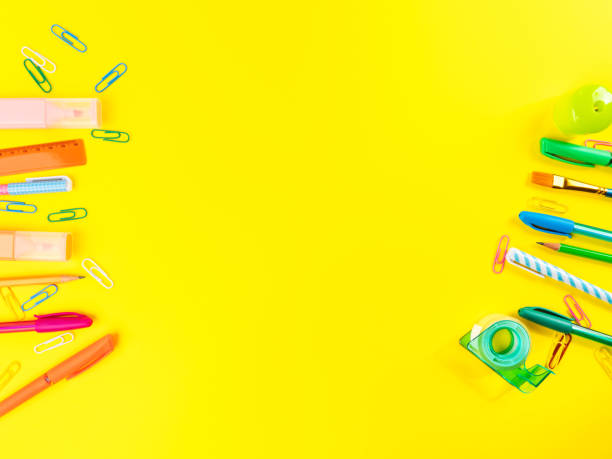 istock Back to school concept. Colorful writing tools frame on yellow background 1331327920