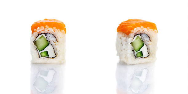 istock Set of three sushi rolls on a white plate with reflection. Sushi roll with rice, tofu cheese, flying fish roe, crab meat and avocado, salmon. Sushi menu. Japanese and Asian cuisine, restaurant. 1331329079
