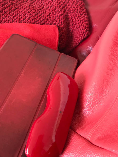 istock red knitted blanket, cushion, iPad and spectacle case on a red couch 1331329367