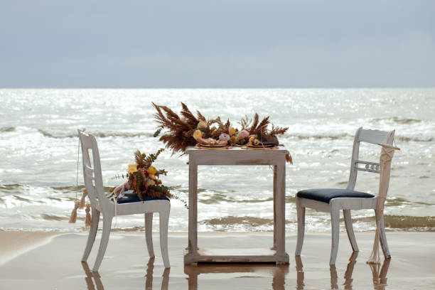 istock A table  designed for a boho style event with an eucalyptus, vintage plates and other rustic touches. On seaside in the sand dunes 1331332968