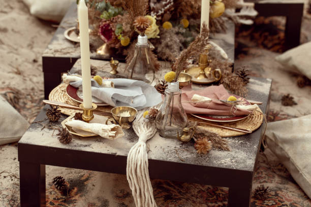 istock A table  designed for a boho style event with an eucalyptus, vintage plates and other rustic touches. On seaside in the sand dunes 1331332975