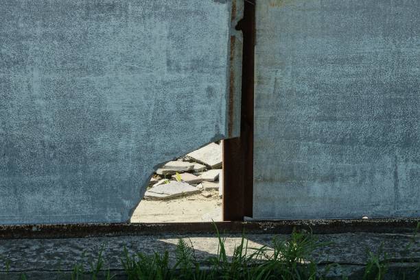 istock part of a gray concrete wall with a big hole 1331335588