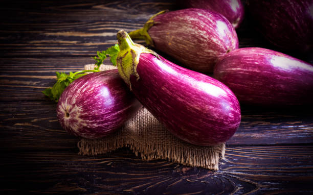 istock whole eggplant on wooden background 1331336399