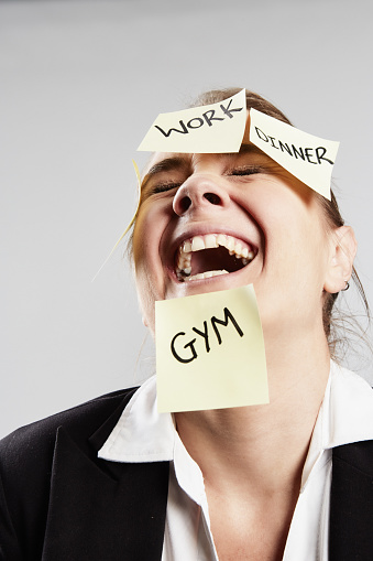 Despairing woman shouts as work-life balance eludes her.