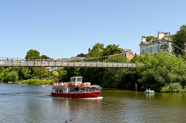 tourist boat on the river dee in chester - chester england dee river suspension bridge bridge imagens e fotografias de stock