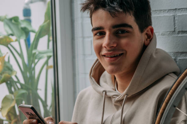 istock young man with mobile phone at home 1331338426