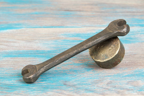istock Vintage bronze wrench on shabby background 1331340324
