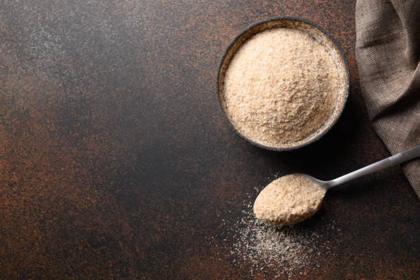 istock Psyllium husk in bowl on dark brown table. 1331340656