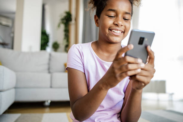 istock Happy teenage smiling and using smart phone at home 1331343404