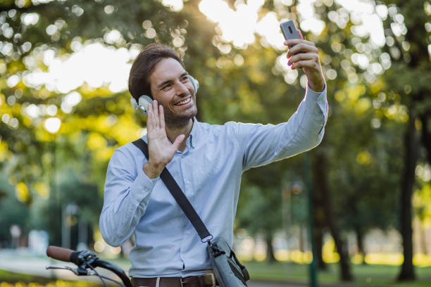 istock Young man on a bicycle is communicating on a video call 1331344569
