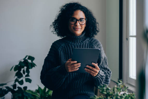 istock Cheerful Woman Using a Digital Tablet at Home 1331344745