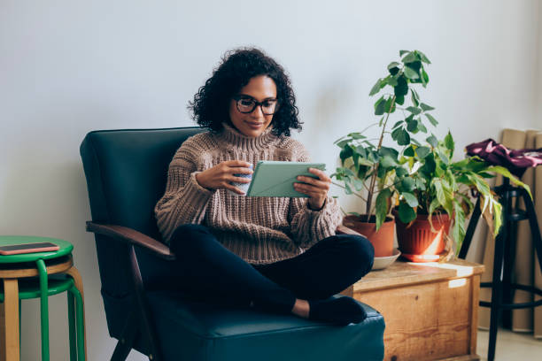 istock Happy Woman Drinking Coffee and Using a Digital Tablet 1331344759