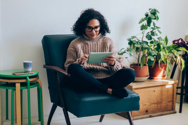istock Beautiful Woman Using a Digital Tablet at Home 1331344763