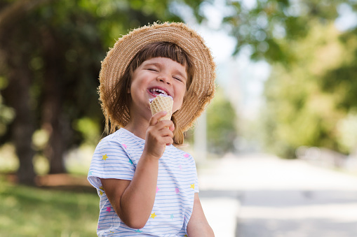 A beautiful little girl eating ice-cream