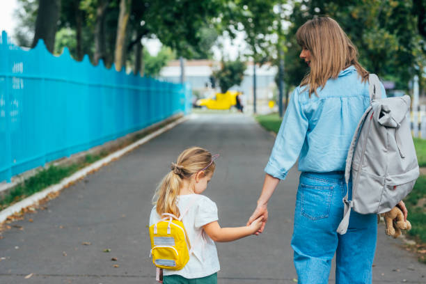 istock Unrecognizable Mother Taking her Daughter to School 1331345413
