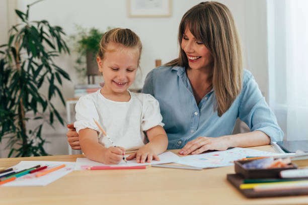 istock Mother Helps her Daughter with Homework 1331345422