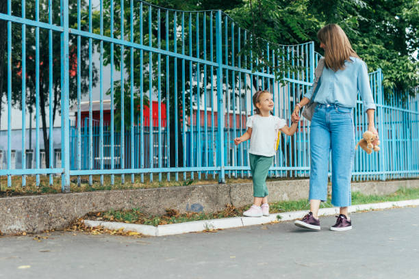 istock Unrecognizable Mother Taking her Daughter to School 1331345585