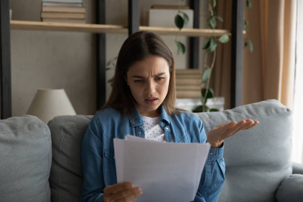 istock Woman read document feels confused due unpleasant notification from bank 1331346486