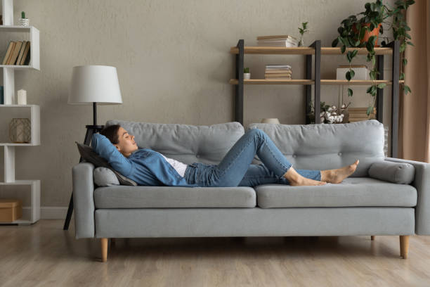 istock Side view woman enjoy day nap on comfy sofa 1331346494