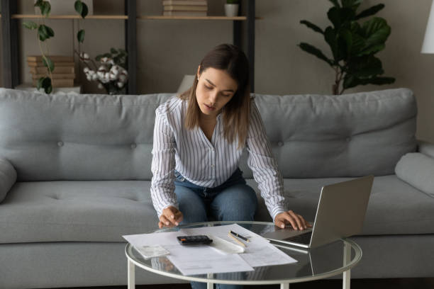 istock Female individual entrepreneur sit on sofa makes financial report 1331346500