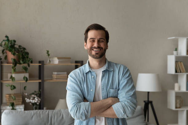 istock Optimistic Caucasian 30s man standing indoor with arms crossed 1331346522