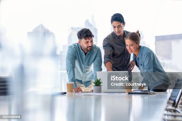 Business Team Working On A Laptop Computer Stock Photo - Download Image Now - Office, Business, Teamwork