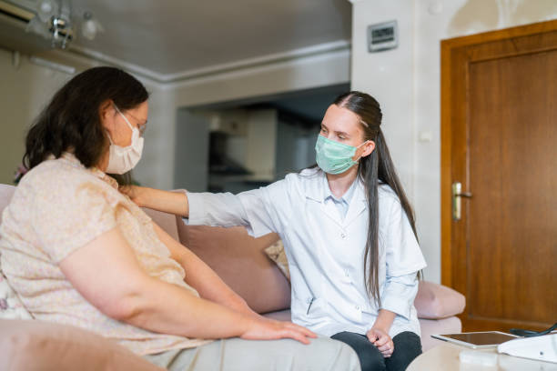 istock Female doctor visiting her patient at her house 1331350021