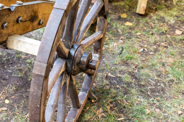 A western saddle hangs on the wagon wheel of a chuck wagon. This still life conveys the western life style of the cowboys. At the end of the day they'd have dinner perhaps bean and biscuits. A barrel of water is seen on the wooden wagon.