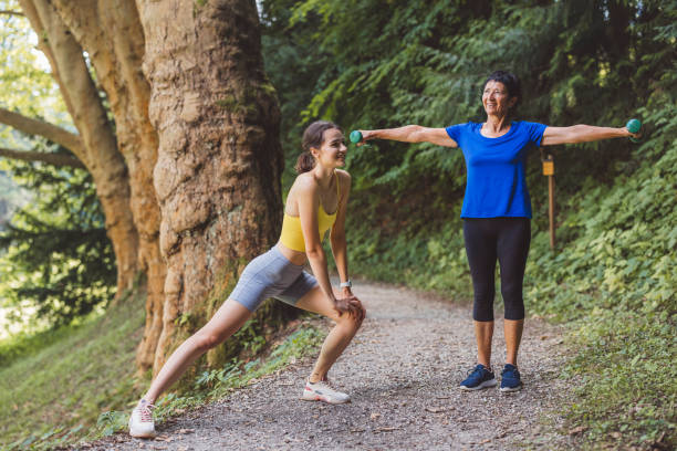 istock Young woman and active senior woman stretching before a run 1331354686