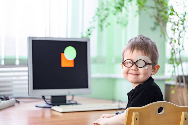 A little boy wearing glasses and an eye patch (plaster, occluder