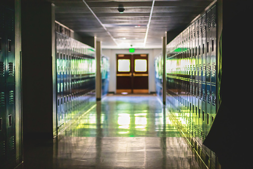 In Western Colorado Empty School Hallway Lined with Lockers Education Photo Series (Shot with Canon 5DS 50.6mp photos professionally retouched - Lightroom / Photoshop - original size 5792 x 8688 downsampled as needed for clarity and select focus used for dramatic effect)