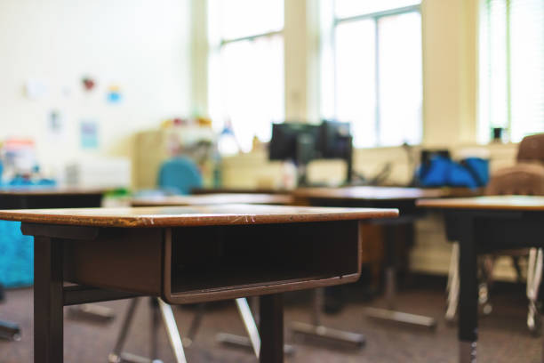 Retro Education Desks In a Classroom Photo Series In Western Colorado Education Desks In a Classroom (Shot with Canon 5DS 50.6mp photos professionally retouched - Lightroom / Photoshop - original size 5792 x 8688 downsampled as needed for clarity and select focus used for dramatic effect) empty desk in classroom stock pictures, royalty-free photos & images