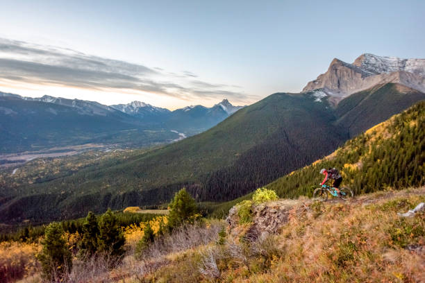 istock View of mountain biker descending grassy mountain ridge 1331365008