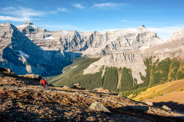 istock Mountain biker follows trail down mountain ridge 1331365437