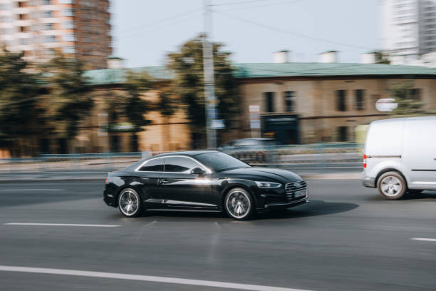 Ukraine, Kyiv - 16 July 2021: Black Audi A5 car moving on the street. Editorial