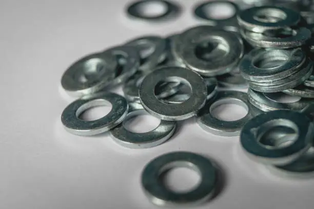 Photo of A scattering of metal washers for bolts and screws.