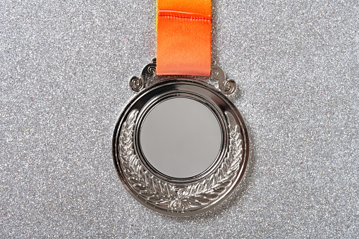 top view silver medal on a silver background