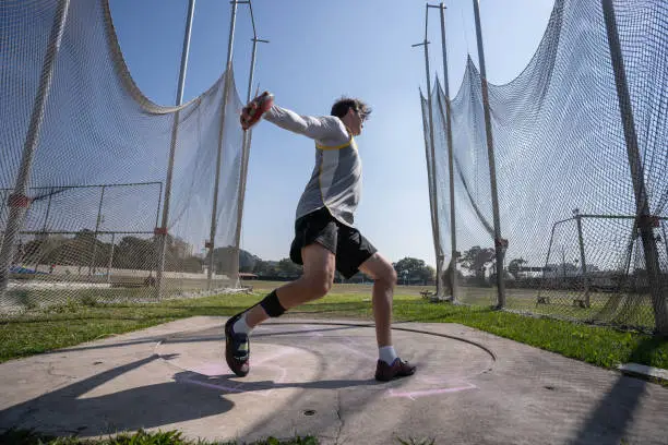 athlete with motor impairment training discus throw