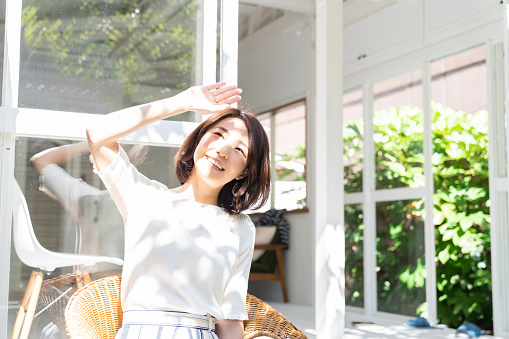 young attractive asian woman relaxing, garden, bright